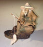 Ceramic Figurine  Mud Man Sitting On A Rock Fishing