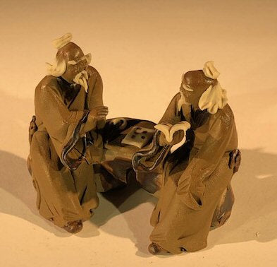 Ceramic Figurine Two Mud Men Sitting On A Bench Reading Books - 2.5"