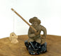 Glazed Fisherman Figurine Sitting on a Rock - 1.75"