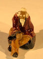 Miniature Ceramic Figurine   Man Sitting on Bench 2"