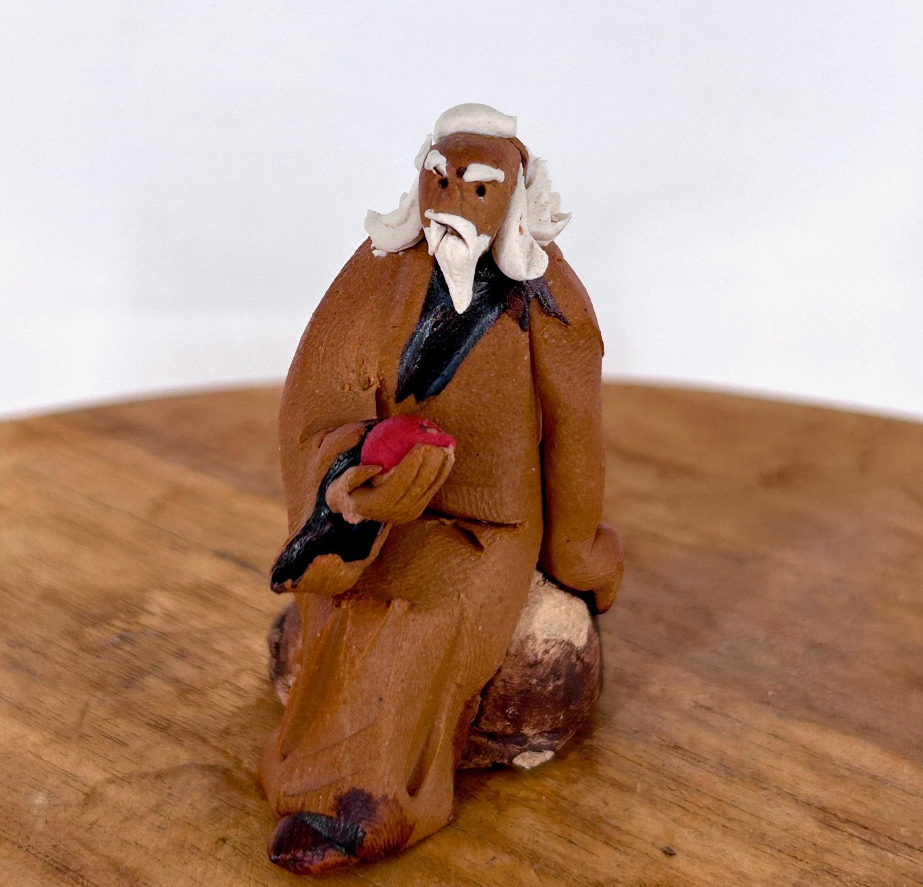 Miniature Ceramic Figurine  Mud Man Holding Fruit - 1.75"